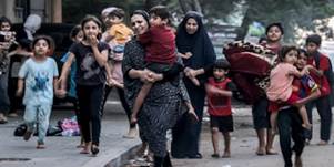 Palestinian women flee their homes with their children, after Israeli air strikes in Gaza city. AFP